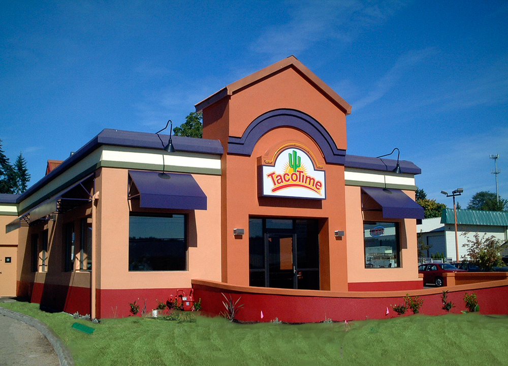 A Taco Time Franchise location with purple siding and a freshly mowed lawn